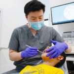 Dr. Cheng performing a dental exam