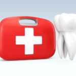 A white tooth floats next to a red and white dental first aid kid to indicate a dental emergency