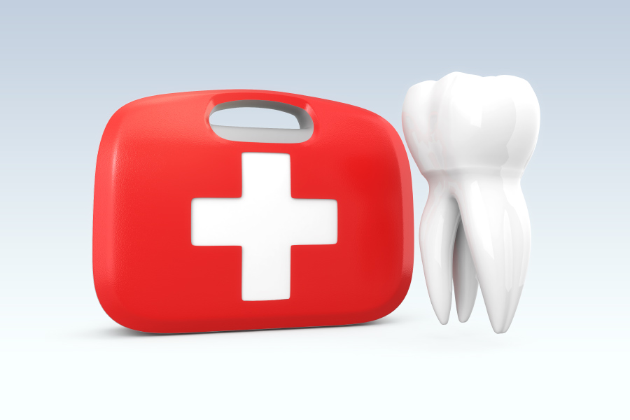 A white tooth floats next to a red and white dental first aid kid to indicate a dental emergency